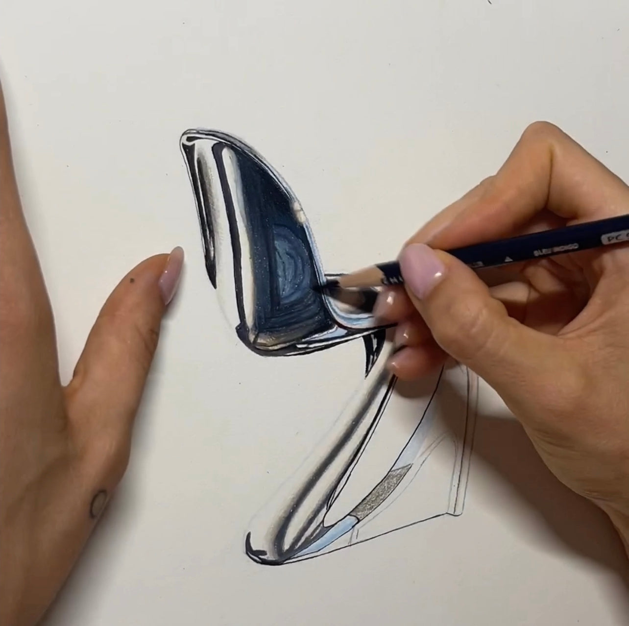 Artist, Bella McGoldrick, drawing a Panton chair with colored pencil.